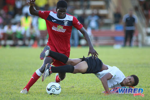 Photo: Fyzabad midfield bouncer Kaylon Padilla (left) bowls over St Anthony's College captain Jules Lee during SSFL Premier Division action on 24 September 2016 at Fyzabad. (Courtesy Chevaughn Christopher/Wired868)