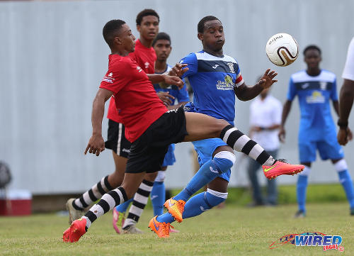 Photo: Fyzabad captain Sharkeel Louison (right) tries to take the ball past a Pleasantville opponent during SSFL Premier Division action at the Mahaica Oval on 17 September 2016. (Courtesy Sean Morrison/Wired868)