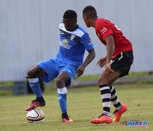 Photo: A Fyzabad Secondary player (left) tries to out a Pleasantville Secondary opponent during SSFL Premier Division action at the Mahaica Oval on 17 September 2016. (Courtesy Sean Morrison/Wired868)