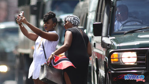 Photo: Two spectators take a selfie during Trinidad and Tobago's 2016 Independence Day Parade celebrations. (Courtesy Chevaughn Christopher/Wired868)