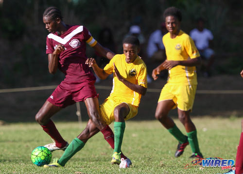 Photo: Giant East Mucurapo captain Akquinde Marslin (left) tries to turn past a Signal Hill opponent during SSFL Premier Division action at Moka on 14 September 2016. (Courtesy Sean Morrison/Wired868)