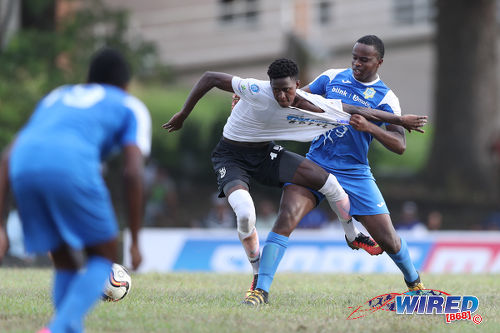 Photo: Naparima College forward Isaiah Lee (centre) holds off Presentation College (San Fernando) left back Darnell Hospedales (right) during SSFL Premier Division action at Lewis Street, San Fernando on 28 September 2016. Lee scored one and set up another as Naparima won 2-0. (Courtesy Allan V Crane/Wired868)