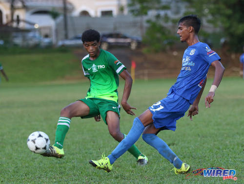 Photo: Naparima College midfielder Justin Sadoo (right) passes the ball past a Trinity College Moka opponent during SSFL Premier Division action on 21 September 2016 at Moka. (Courtesy Sean Morrison/Wired868)