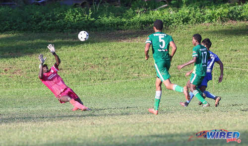 Photo: Trinity College Moka goalkeeper Desean Bowen (far left) tries in vain to save a chipped effort from Naparima College attacker Mark Ramdeen (far left) while his defenders (second from left) Isaiah Alexander and Raheem Jawahir look on during SSFL Premier Division action on 21 September 2016 at Moka. (Courtesy Sean Morrison/Wired868)