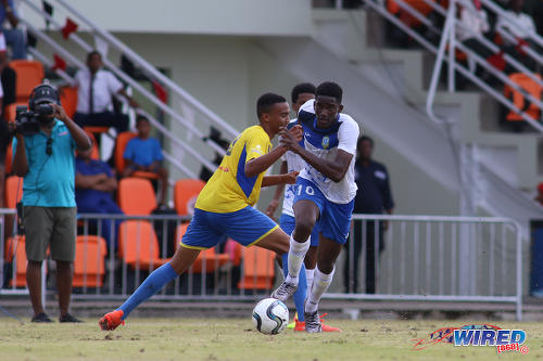 Photo: Presentation College midfielder Kareem Riley (right) runs with the ball during SSFL Premier Division action against Shiva Boys HC at Irwin Park, Siparia on 7 September 2016. (Courtesy Chevaughn Christopher/Wired868)