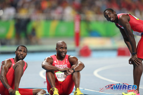 Photo: Trinidad and Tobago sprinters (from left) Richard Thompson, Emmanuel Callender and Rondel Sorrillo watch the electronic scoreboard after their disqualification from the 4x100 metre event during the Rio 2106 Olympic Games. (Courtesy Allan V Crane/Wired868)