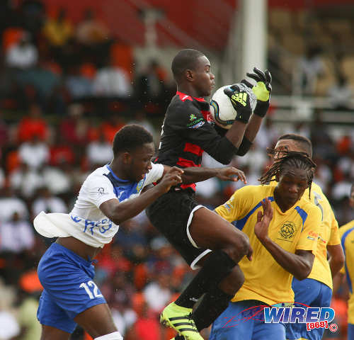 Photo: Shiva Boys HC goalkeeper Denzel Smith (centre) catches the ball during SSFL Premier Division action at Irwin Park, Siparia on 7 September 2016. Shiva Boys whipped Presentation College 3-1. (Courtesy Chevaughn Christopher/Wired868)