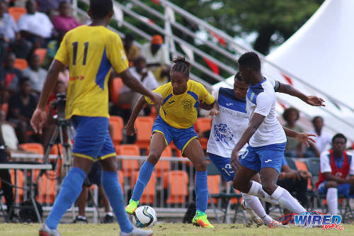 Photo: Shiva Boys HC midfielder Tyrel "Pappy" Emmanuel (second from left) tries to keep the ball from Presentation College players Jarod Gordon (second from right) and Kareem Riley (far right) while Shiva teammate Yohannes Richardson looks on during SSFL Premier Division action at Irwin Park, Siparia on 7 September 2016. Shiva Boys won 3-1. (Courtesy Chevaughn Christopher/Wired868)