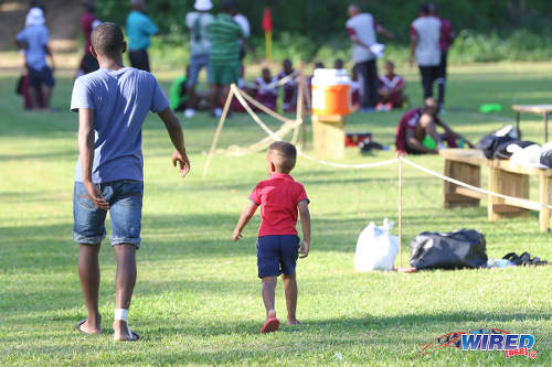 Photo: We dem boys! Two patrons take a stroll during halftime of a SSFL Premier Division fixture between East Mucurapo and Signal Hill at Moka on 14 September 2016. (Courtesy Sean Morrison/Wired868)