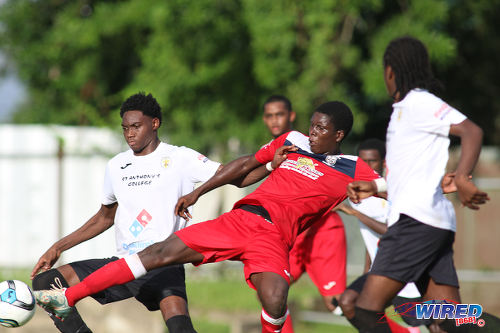 Photo: St Anthony's College attacker Kathon St Hillaire (left) holds off Fyzabad Secondary midfielder Kaylon Padilla (centre) during SSFL Premier Division action on 24 September 2016 at Fyzabad. (Courtesy Chevaughn Christopher/Wired868)