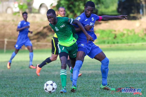 Photo: Trinity College midfielder Saleem Henry (left) tries to hold off Naparima College captain Shane Sandy during SSFL Premier Division action on 21 September 2016 at Moka. (Courtesy Sean Morrison/Wired868)