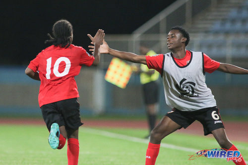 Photo: Trinidad and Tobago National Under-17 Team playmaker Che Bennett (left) gets a high five from substitute Brandon Semper during 2017 World Cup qualifying action against Bermuda at the Ato Boldon Stadium on 18 September 2016. (Courtesy Chevaughn Christopher/Wired868)