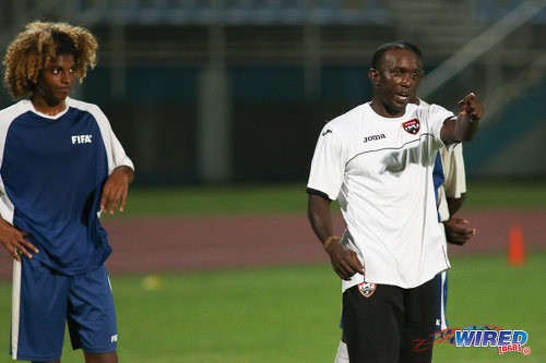 Photo: Former Trinidad and Tobago 2006 World Cup captain and Manchester United star Dwight Yorke (right) gives instructions to National Under-17 midfielder Luke Singh. (Courtesy Chevaughn Christopher/Wired868)