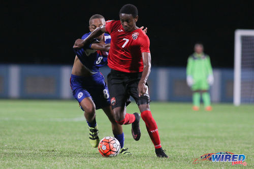 Photo: Trinidad and Tobago National Under-17 Team midfielder Isaiah Hudson (right) tries to hold off Bermuda captain Zuhri Burgess during 2017 World Cup qualifying action at the Ato Boldon Stadium on 18 September 2016. (Courtesy Chevaughn Christopher/Wired868)