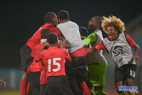 Photo: Trinidad and Tobago National Under-17 Team substitute Luke Singh (far right) joins in the celebrations after their 3-2 comeback win over Bermuda in 2017 World Cup qualifying action at the Ato Boldon Stadium, Couva on 18 September 2016. (Courtesy Chevaughn Christopher/Wired868)