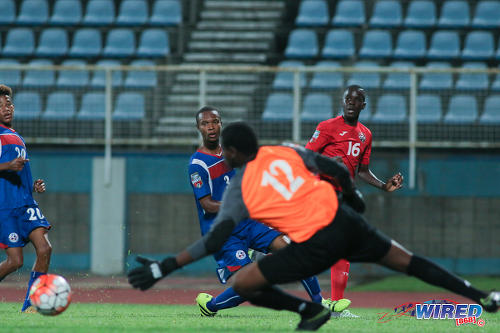 Photo: Trinidad and Tobago National Under-17 Team winger Nickel Orr (right) whips a low cross past Bermuda goalkeeper Quinaceo Hunt during 2017 World Cup qualifying action at the Ato Boldon Stadium on 18 September 2016. (Courtesy Chevaughn Christopher/Wired868)