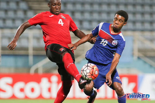 Photo: Bermuda attacking midfielder Kane Crichlow (right) pressures Trinidad and Tobago defender Tyrique Andrews during 2017 Under-17 World Cup qualifying action at the Ato Boldon Stadium on 18 September 2016. (Courtesy Chevaughn Christopher/Wired868)