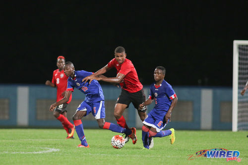 Photo: Trinidad and Tobago substitute Jaydon Prowell (centre) tries to get past Haiti midfielders Obenson Laveille (left) and Jean Danley during 2017 Under-17 World Cup qualifying action in Couva on 17 September 2016. Haiti won 2-0. (Courtesy Chevaughn Christopher/Wired868)