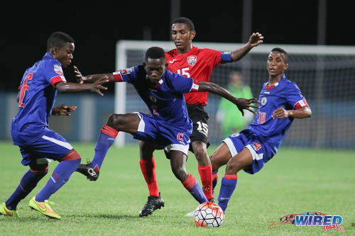 Photo: Trinidad and Tobago midfielder John-Paul Rochford (centre) is closed down by the Haiti trio of (from left) Obenson Laveille, Jolicoeur Etienne and Marc Martine during 2017 Under-17 World Cup qualifying action in Couva on 17 September 2016. Haiti won 2-0. (Courtesy Chevaughn Christopher/Wired868)