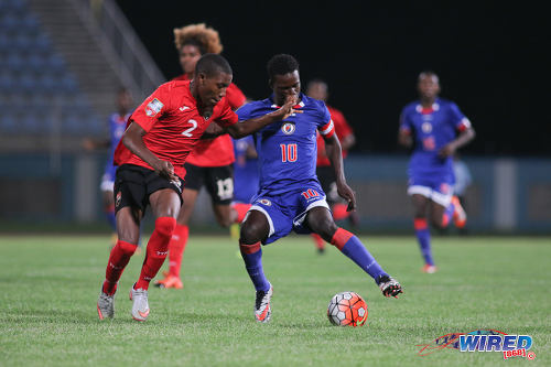 Photo: Haiti star Steeve Saint Duc (right) tries to take the ball past Trinidad and Tobago right back Kerdell Sween during 2017 Under-17 World Cup qualifying action in Couva on 17 September 2016. Saint Duc scored once as Haiti won 2-0. (Courtesy Chevaughn Christopher/Wired868)