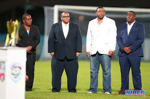 Photo: Caribbean Football Union (CFU) president Gordon Derrick (second from left) is sandwiched by TTFA president David John-Williams (second from right) and TTFA employee Sharon O'Brien (far left) before the CFU Under-17 final on 25 September 2016 at the Ato Boldon Stadium. John-Williams tried unsuccessfully to replace Derrick as CFU president on 23 July 2016. (Courtesy Allan V Crane/Wired868)