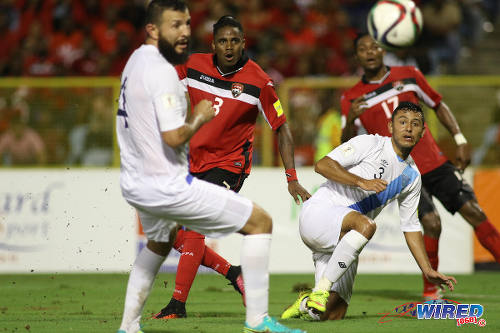 Photo: Trinidad and Tobago winger Joevin Jones (centre) steers home his second goal while Guatemala defenders Christian Jimenez (right) and Hamilton Lopez look on during Russia 2018 World Cup qualifying action at the Hasely Crawford Stadium, Port of Spain on 2 September 2016. Jones struck twice in a 2-2 draw between the two nations. (Courtesy Chevaughn Christopher/Wired868)