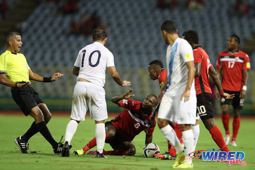 Photo: Referee John Patti (far left) tries to calm things down as Trinidad and Tobago midfielder Khaleem Hyland (centre) remonstrates with Guatemala playmaker Jose Contreras (second from left) during 2018 World Cup qualifying action at the Hasely Crawford Stadium, Port of Spain on 2 September 2016. (Courtesy Allan V Crane/CA-Images/Wired868)