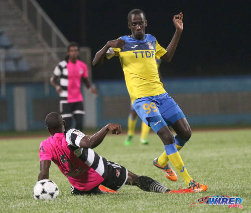 Photo: Defence Force midfielder Jerwyn Balthazar (right) flicks the ball around Central FC defender Andre Ettienne during Pro League action at the Ato Boldon Stadium in Couva on 14 October 2016. (Courtesy Sean Morrison/Wired868)