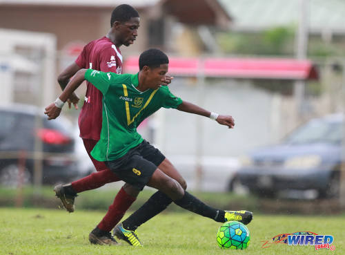 Photo: St Benedict's College midfielder Jaycee Paras (right) tries to turn on an East Mucurapo Secondary opponent during SSFL Premier Division action at Mucurapo Road on 6 October 2016. (Courtesy Nicholas Bhajan/Wired868)