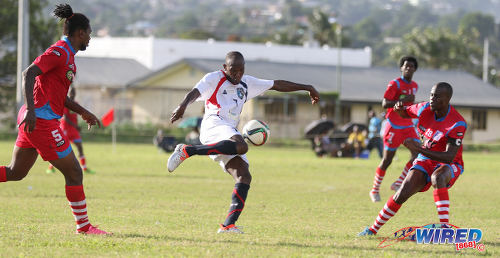 Photo: Morvant Caledonia United frontman Kordell Samuel (centre) shapes to strike the ball between St Ann's Rangers defenders Shakiyl Phillip (right) and Devon Drayton during Pro League action at the Barataria Recreation Ground on 9 October 2016. (Courtesy Sean Morrison/Wired868)