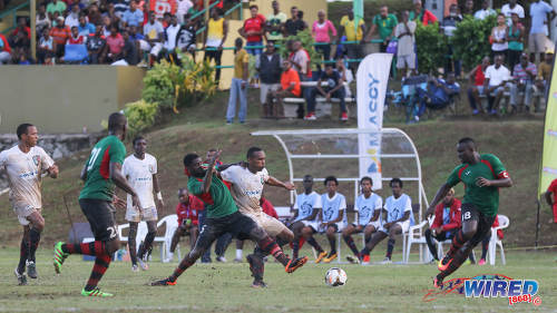 Photo: Morvant Caledonia United captain Akim Armstrong (centre) tries to hold off San Juan Jabloteh defender Aquil Selby (second from left) while Jevon Morris (right) looks on during Pro League action at the Morvant Recreation Ground on 16 October 2016. (Courtesy Sean Morrison/Wired868)