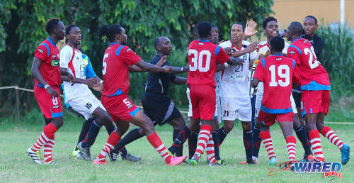 Photo: Morvant Caledonia United veteran and ex-Trinidad and Tobago 2006 World Cup player Densill Theobald (centre, white shirt) finds himself in the middle of a brawl during Pro League action against St Ann's Rangers at the Barataria Recreation Ground on 9 October 2016. Refee Keilon Bacchus (fourth) from left ejected Morvant Caledonia attacker Jameel Neptune and Rangers defender Shakiyl Phillip once the dust had settled. (Courtesy Sean Morrison/Wired868)