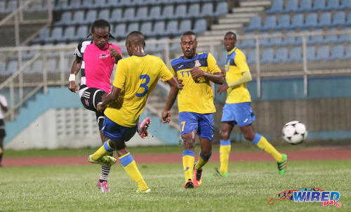 Photo: Central FC captain Darren Mitchell (centre) shoots through a crowd of Defence Force players during Pro League action at the Ato Boldon Stadium in Couva on 14 October 2016. (Courtesy Sean Morrison/Wired868)