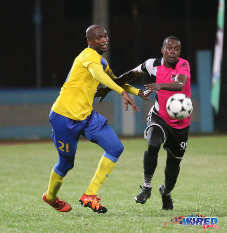 Photo: Central FC attacker Marcus Joseph (right) and Defence Force defender Akile Edwards tussle for possession during Pro League action at the Ato Boldon Stadium in Couva on 14 October 2016. (Courtesy Sean Morrison/Wired868)