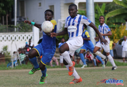 Photo: Shiva Boys Hindu College winger Quinn Rodney (left) tries to get away from St Mary's College defender Nathan Harte during SSFL Premier Division action at Lachoo Road on 19 October 2016. (Courtesy Sean Morrison/Wired868)