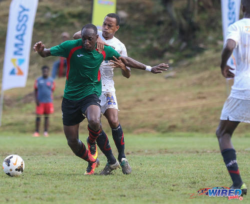 Photo: Morvant Caledonia United midfielder Densill Theobald (centre) tries to hang on to San Juan Jabloteh winger Noel Williams during Pro League action at the Morvant Recreation Ground on 16 October 2016. (Courtesy Sean Morrison/Wired868)