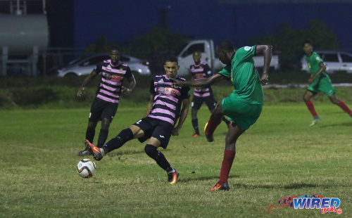 Photo: San Juan Jabloteh full back Noel Williams (right) fires past Ma Pau Stars right back Carlos Edwards during Pro League action at the Barataria Recreation on 23 October 2016. (Courtesy Sean Morrison/Wired868)