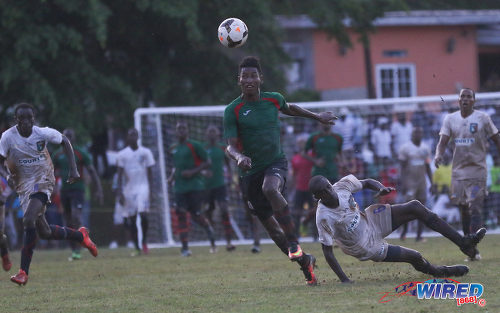 Photo: San Juan Jabloteh striker Willis Plaza (centre) leaves fallen Morvant Caledonia United defender Taje Commissiong for dead during Pro League action at the Morvant Recreation Ground on 16 October 2016. (Courtesy Sean Morrison/Wired868)