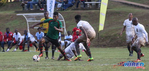 Photo: San Juan Jabloteh striker Willis Plaza (left) takes on the Morvant Caledonia United defence during Pro League action at the Morvant Recreation Ground on 16 October 2016. (Courtesy Sean Morrison/Wired868)