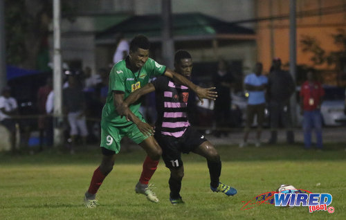 Photo: San Juan Jabloteh striker Willis Plaza (left) challenges Ma Pau Stars midfielder Elton John during Pro League action at the Barataria Recreation on 23 October 2016. (Courtesy Sean Morrison/Wired868)