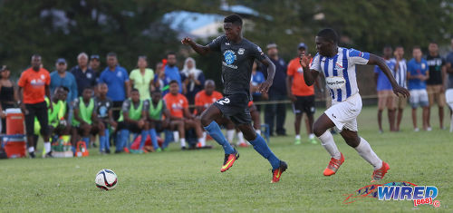 Photo: Naparima College attacker Isaiah Lee (left) takes on St Mary's College defender Nathan Harte during SSFL Premier Division action at Serpentine Road on 8 October 2016. (Courtesy Sean Morrison/Wired868)