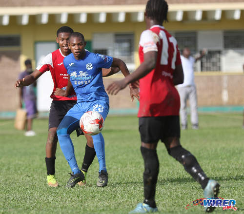 Photo: Naparima College midfielder Renaldo Francois (centre) holds off a St Anthony's College opponent during SSFL Premier Division action at Westmoorings on 15 October 2016. (Courtesy Sean Morrison/Wired868)