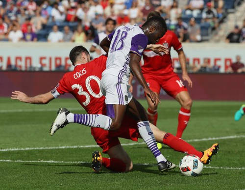 Photo: Chicago Fire defender Razvan Cocis (left) slides in to a shot by Orlando City midfielder Kevin Molino during an MLS match at Toyota Park on 14 August 2016 in Bridgeview, Illinois. The Fire and Orlando City SC tied 2-2. (Copyright AFP 2016/Jonathan Daniel/Getty Images)