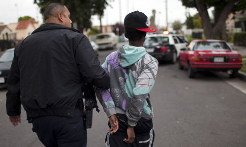 Photo: Police apprehend a young man in Los Angeles. (Copyright Channel4.com)