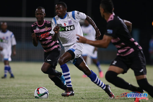 Photo: St Ann's Rangers midfielder Dylon King (centre) charges towards the Ma Pau Stars defence during Pro League action at the Ato Boldon Stadium on 18 October 2016. (Courtesy Chevaughn Christopher/Wired868)