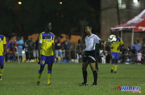 Photo: Referee Crystal Sobers (right) drops the ball for Defence Force captain Jerwyn Balthazar during Pro League action against San Juan Jabloteh at the Barataria Recreation Ground on 9 October 2016. (Courtesy Sean Morrison/Wired868)