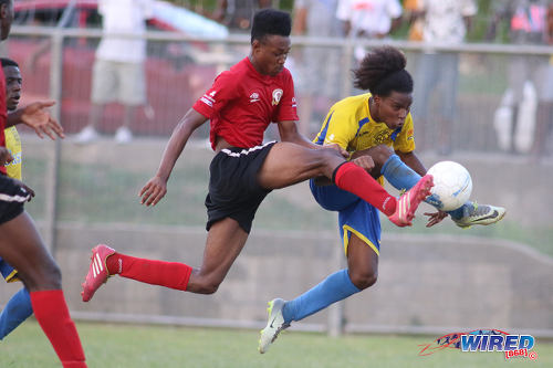 Photo: Shiva Boys Hindu College striker Junior "Barry" Asson (right) tries to squeeze his shot past a Pleasantville Secondary defender during SSFL Premier Division action in Pleasantville on 22 October 2016. (Courtesy Chevaughn Christopher/Wired868)