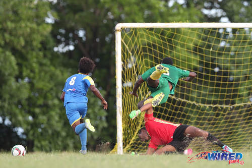 Photo: Shiva Boys Hindu College striker Junior Asson (left) prepares to finish as Signal Hill defender Jokiah Leacock (right) collides with his own goalkeeper during SSFL Premier Division action in Tobago on 5 October 2016. (Courtesy Allan V Crane/CA Images/Wired868)