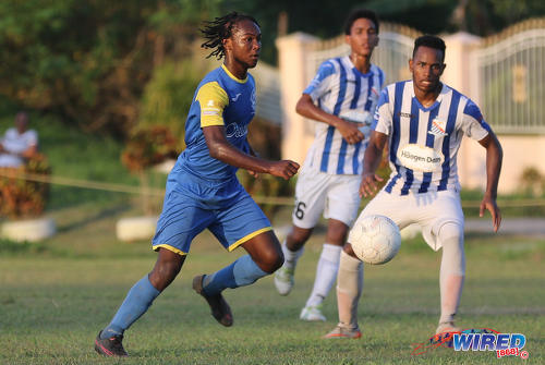 Photo: Shiva Boys Hindu College Tyrel "Sexyman" Baptiste (left) runs with the ball while St Mary's College midfielder Matthaeus Granger during SSFL Premier Division action at Lachoo Road on 19 October 2016. (Courtesy Sean Morrison/Wired868)