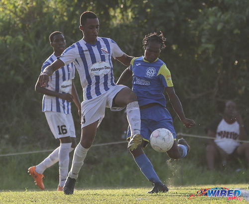 Photo: St Mary's College defender Joshua Joseph (left) tries in vain to stop an effort by Shiva Boys Hindu College attacker Tyrell "Sexyman" Baptiste during SSFL Premier Division action at Lachoo Road on 19 October 2016. (Courtesy Sean Morrison/Wired868)